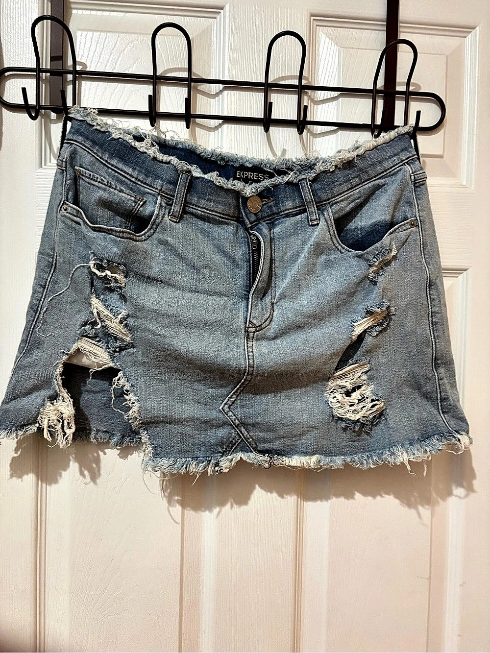 Express High Waisted Distressed Raw Hem Denim Mini Skirt in Blue